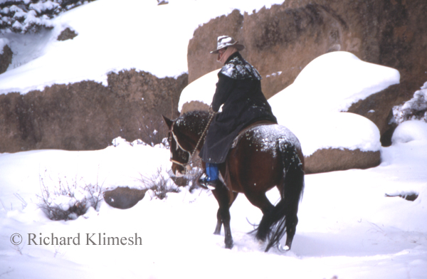 Cherry Hill riding her horse Sassy among snowy rocks