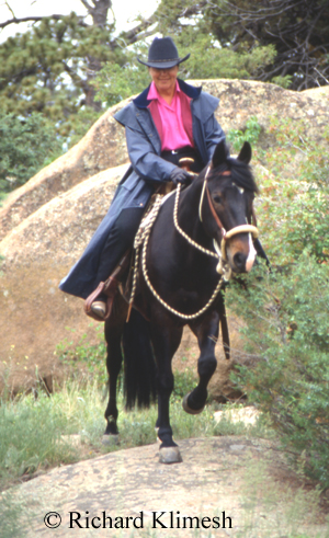 Cherry Hill riding Quarter Horse Zipper across rocks