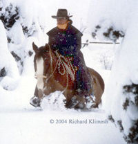 Cherry Hill riding her horse Zinger through deep snow