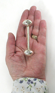 Handheld view showing size of Navajo sterling silver baby rattle by Monica Scott