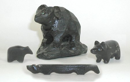 Three black bears and one long fox carvings