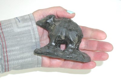 Three black bears and one long fox carvings