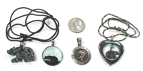 three bear pendants and one kokopelli pendant