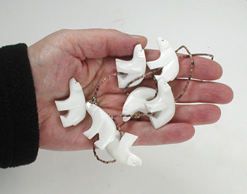 24 inch necklace with Olive Shell heishi and 7 white alabaster bears