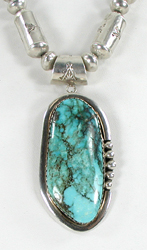 Graduated Stamped sterling silver barrel bead necklace 26 inches long with turquoise pendant