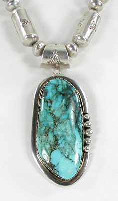 Graduated Stamped sterling silver barrel bead necklace 26 inches long with turquoise pendant