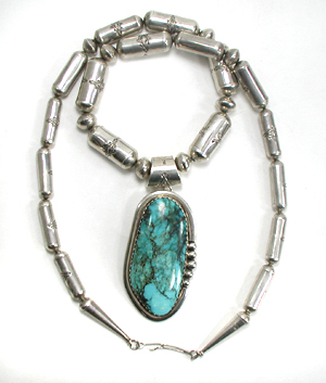 Graduated Stamped sterling silver barrel bead necklace 26 inches long with turquoise pendant