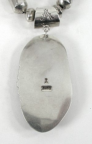 Graduated Stamped sterling silver barrel bead necklace 26 inches long with turquoise pendant